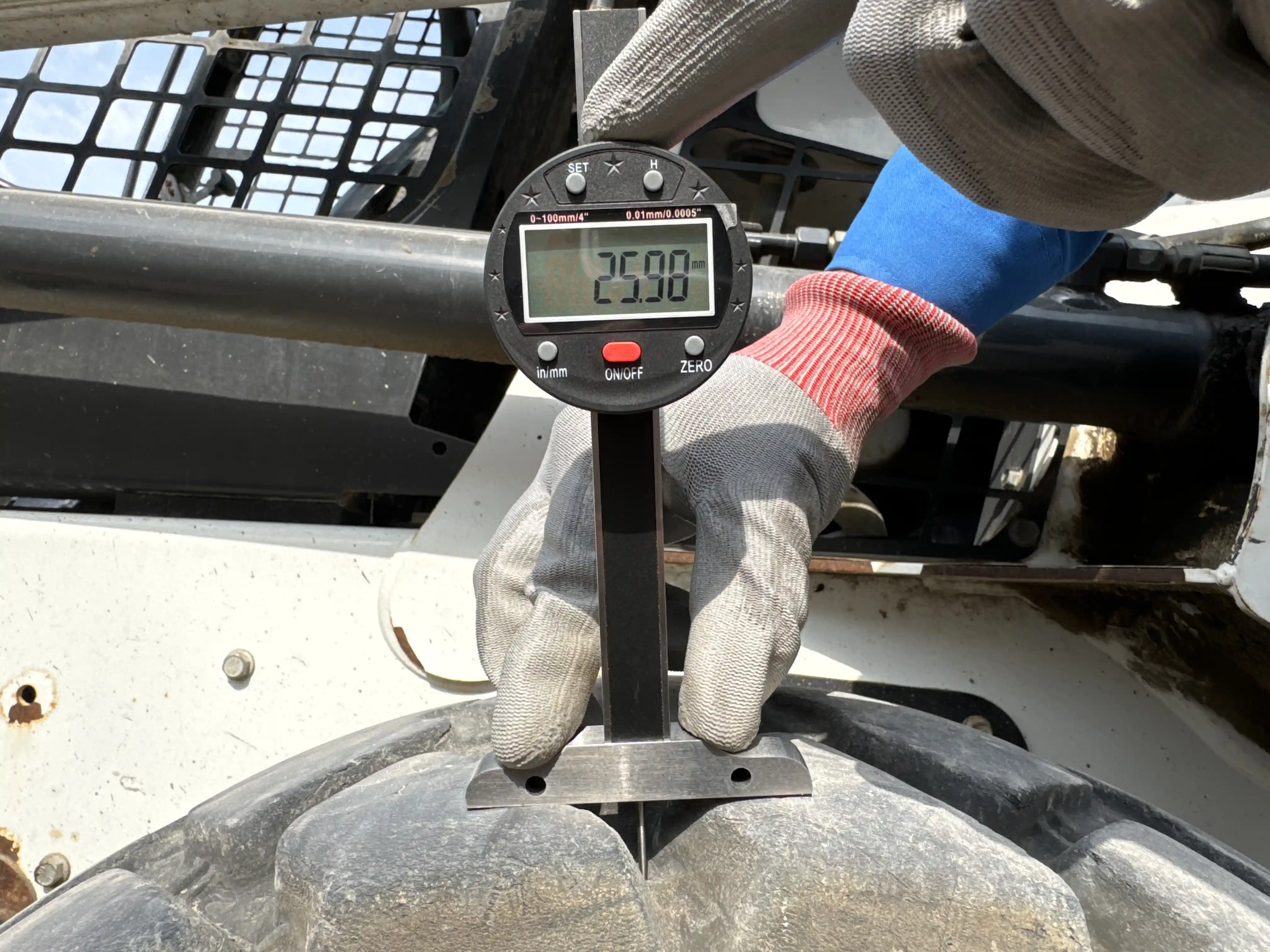 SSL-002-Bobcat-S510-skid-steer-loader-inspection-chassis-left-rear-tire-tread-depth