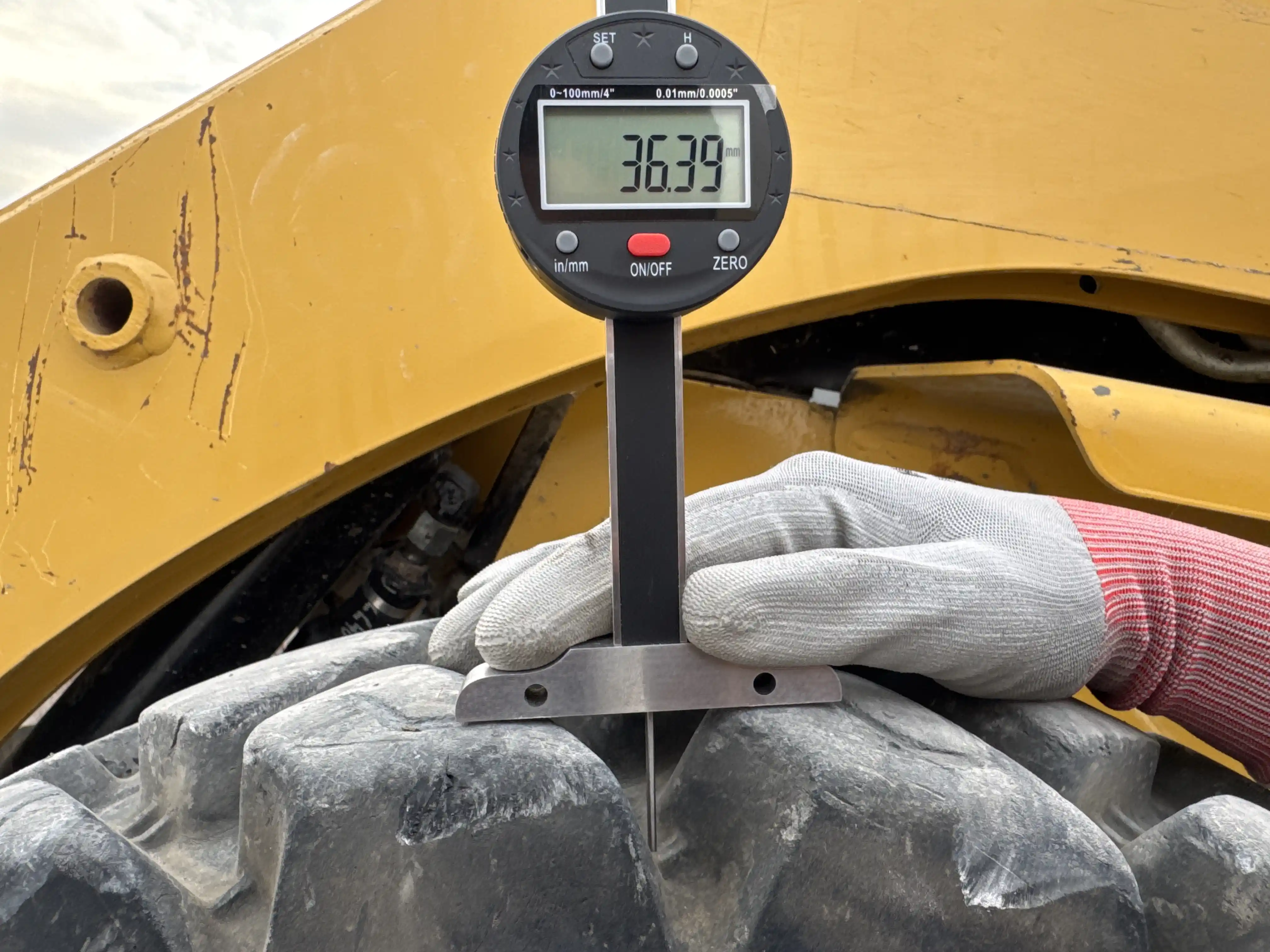 SSL-003-Cat-226B3-skid-steer-loader-inspection-chassis-left-front-tire-tread-depth