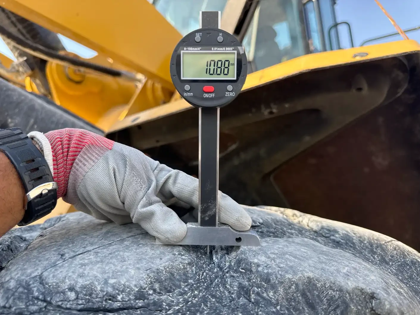 WHL-002-Cat-966L-wheel-loader-inspection-chassis-left-front-tire-tread-depth