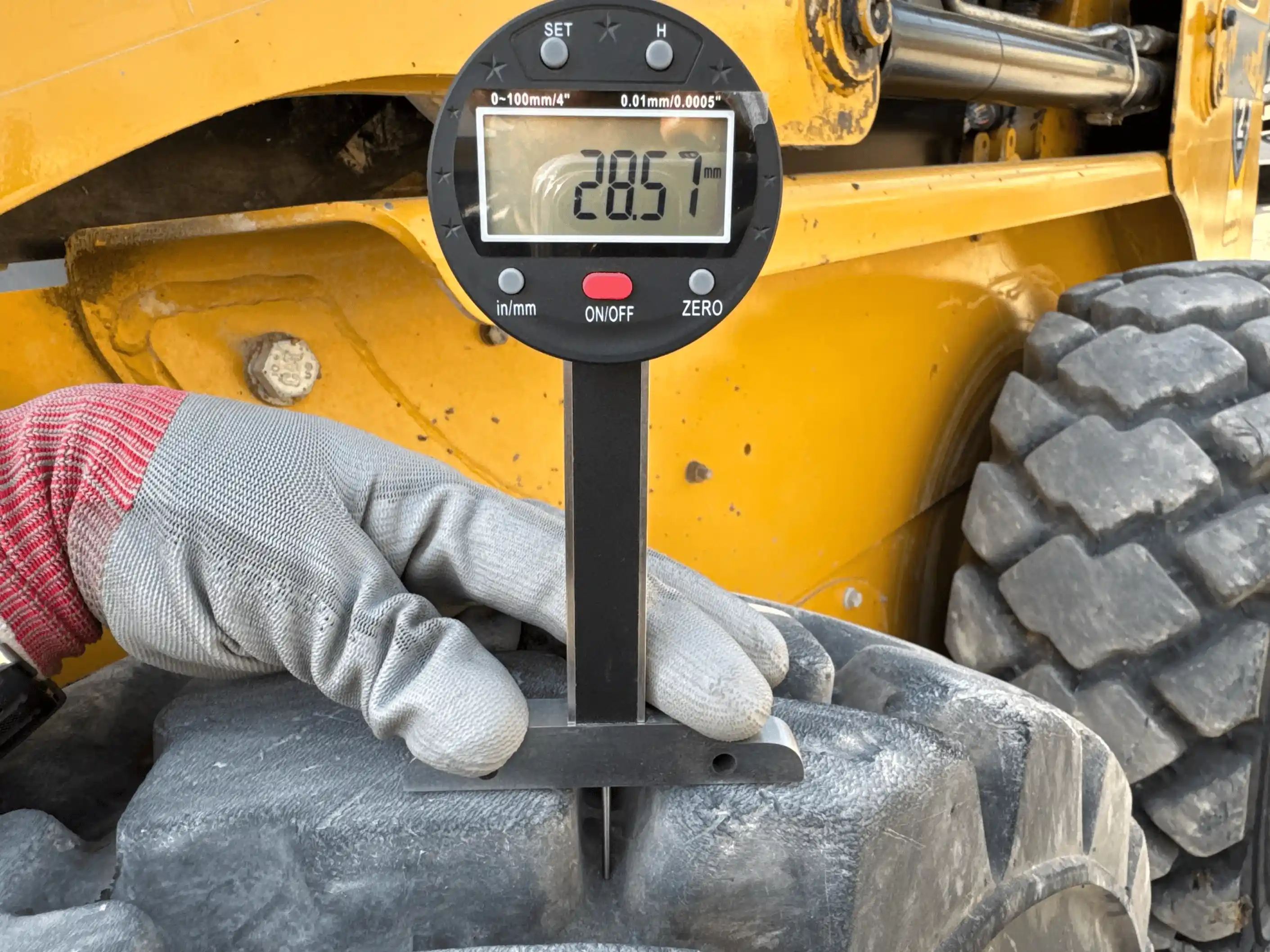 SSL-004-Cat-226B3-skid-steer-loader-inspection-chassis-left-front-tire-tread-depth
