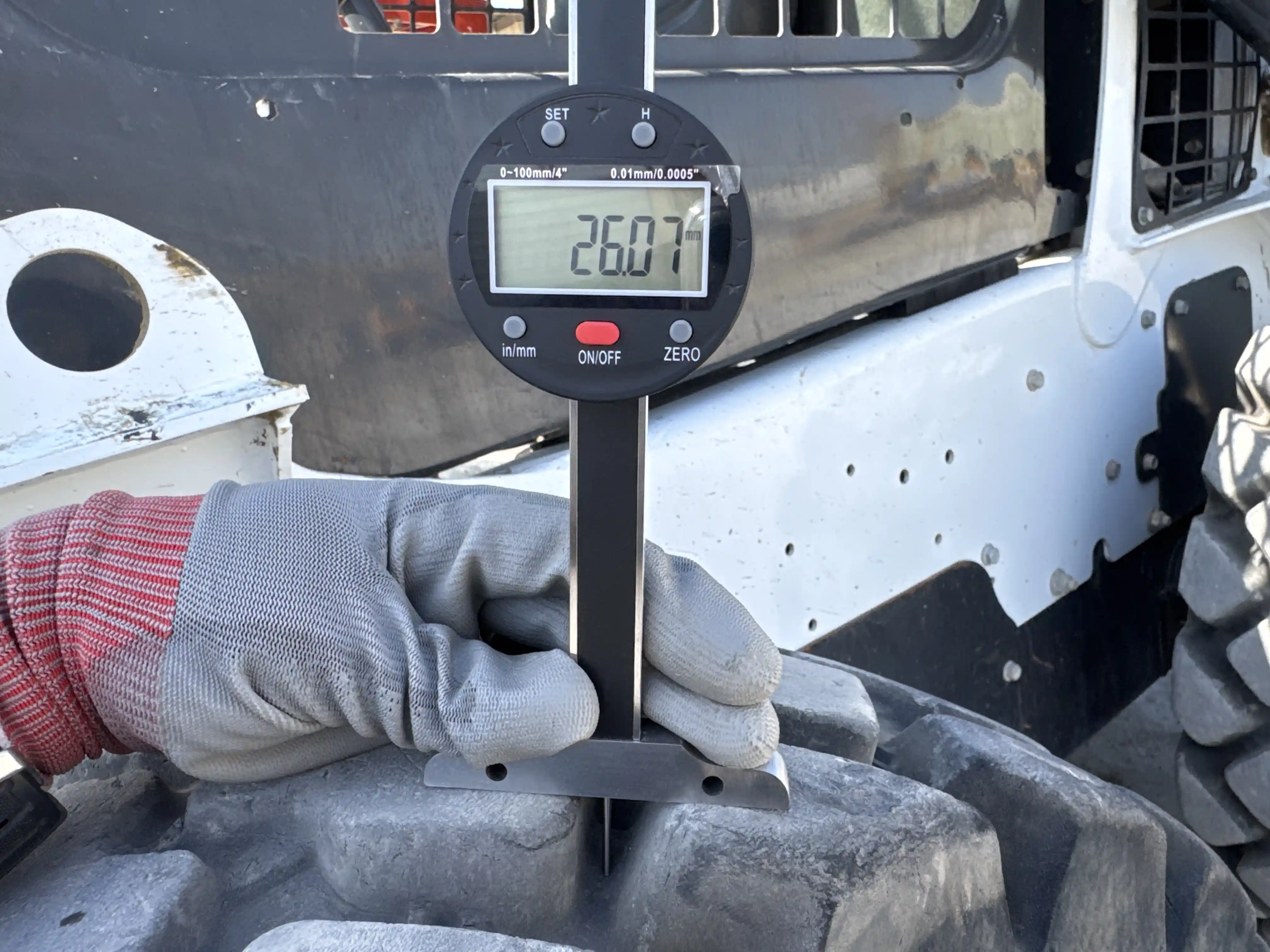 SSL-006-Bobcat-S510-skid-steer-loader-inspection-chassis-left-front-tire-tread-depth