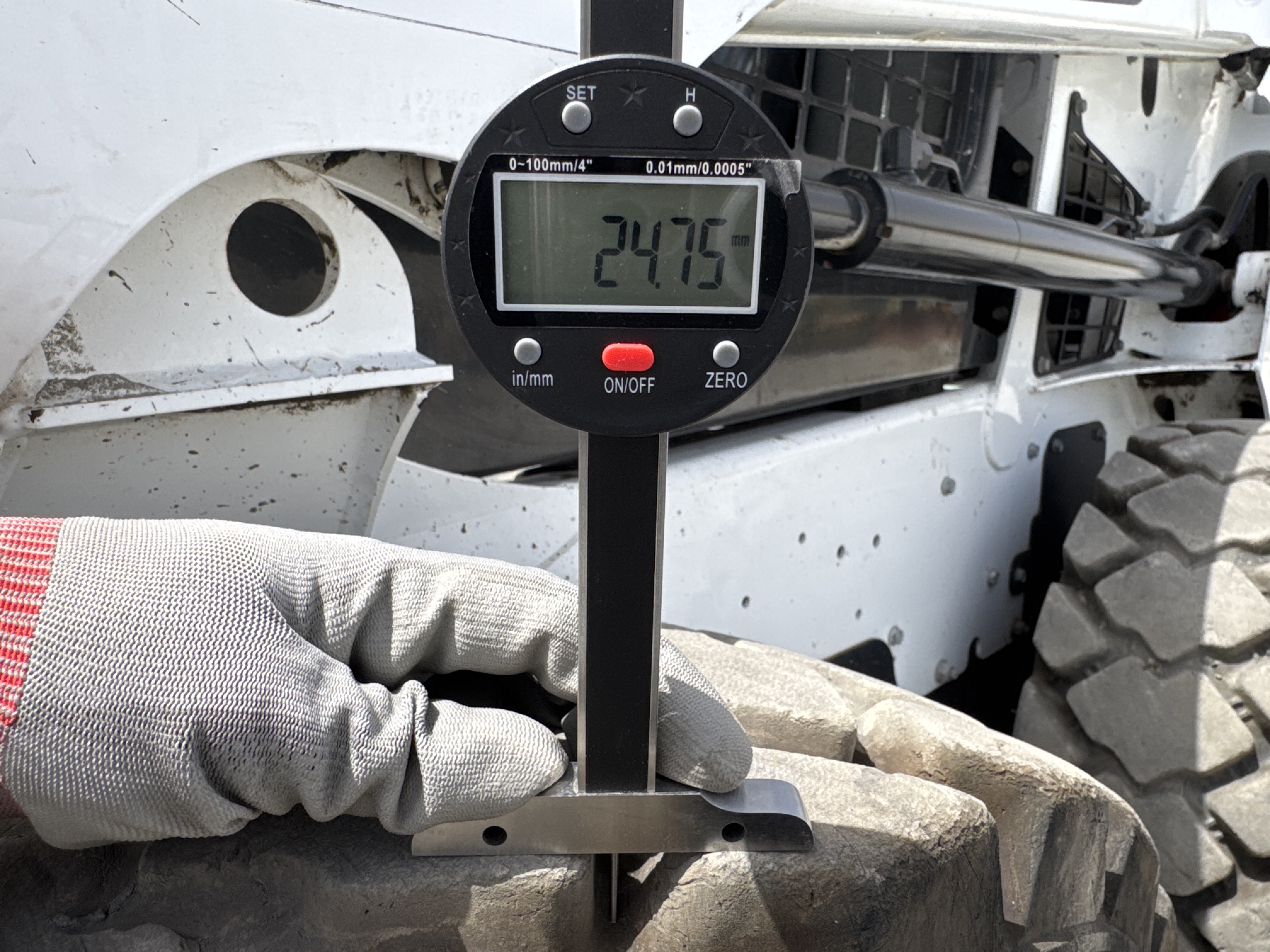 SSL-008-Bobcat-S510-skid-steer-loader-inspection-chassis-left-front-tire-tread-depth