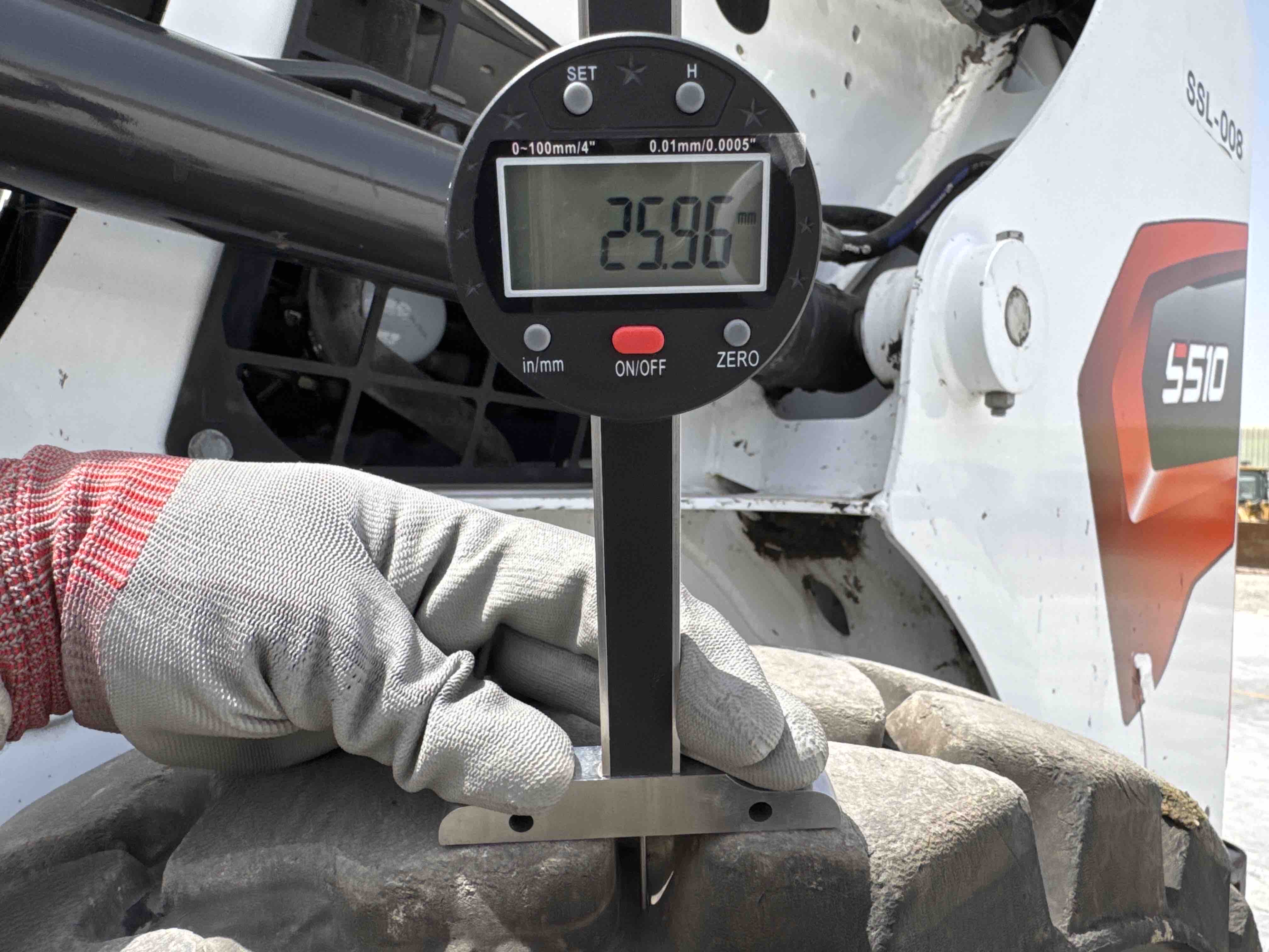 SSL-008-Bobcat-S510-skid-steer-loader-inspection-chassis-left-rear-tire-tread-depth