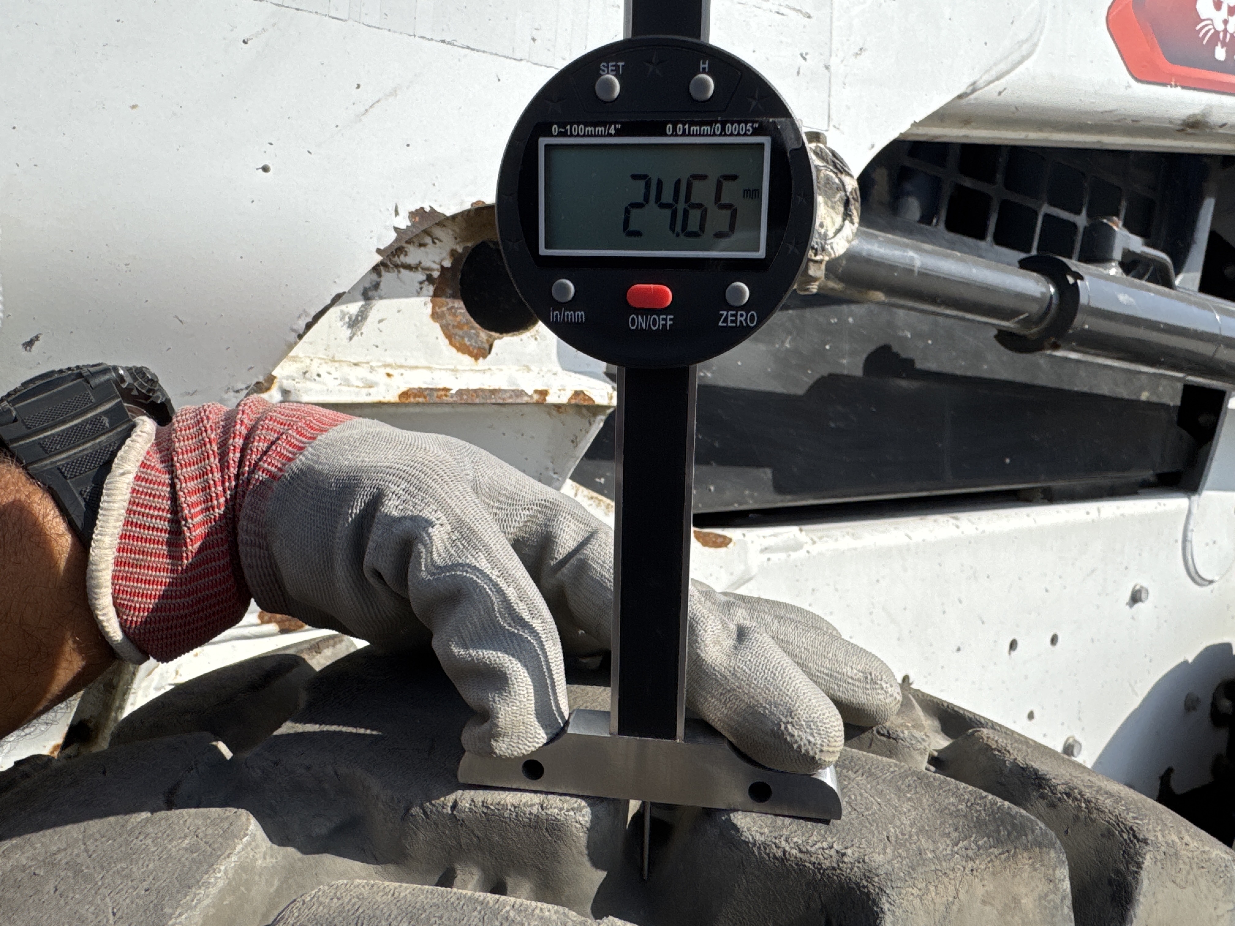 SSL-009-Bobcat-S510-skid-steer-loader-inspection-chassis-left-front-tire-tread-depth