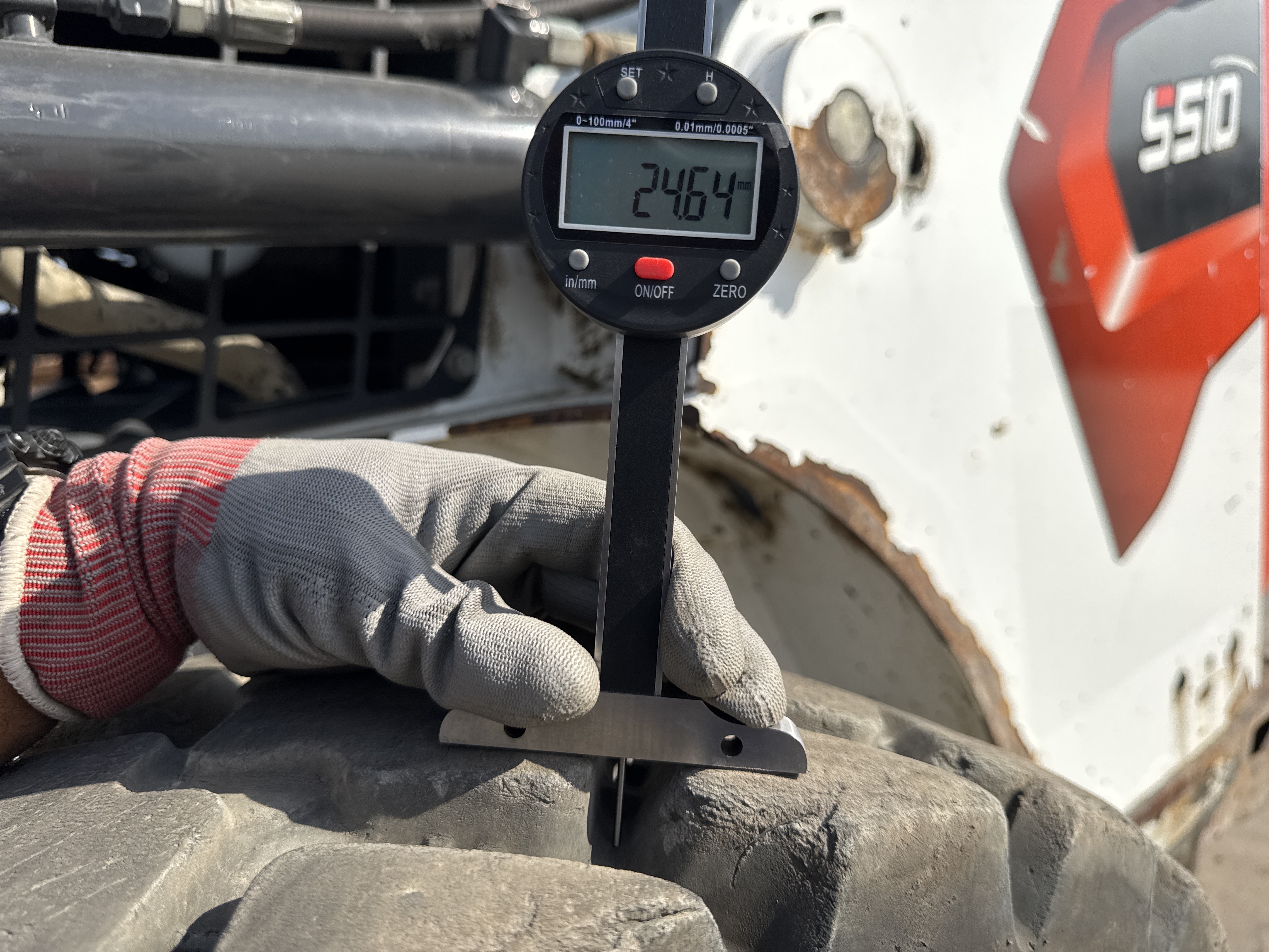 SSL-009-Bobcat-S510-skid-steer-loader-inspection-chassis-left-rear-tire-tread-depth