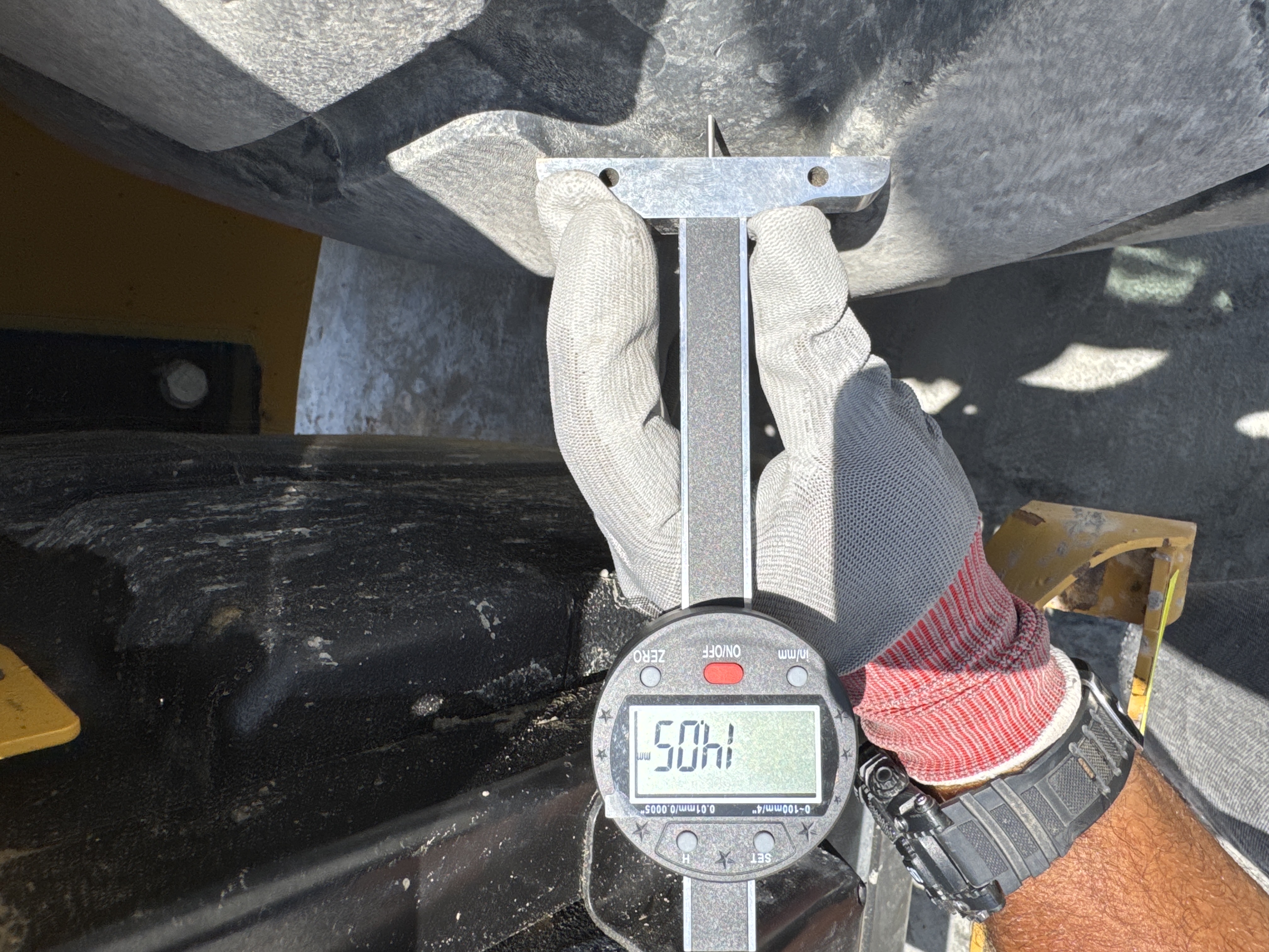 BHL-001-Cat-426F2-backhoe-loader-inspection-chassis-left-rear-tire-tread-depth