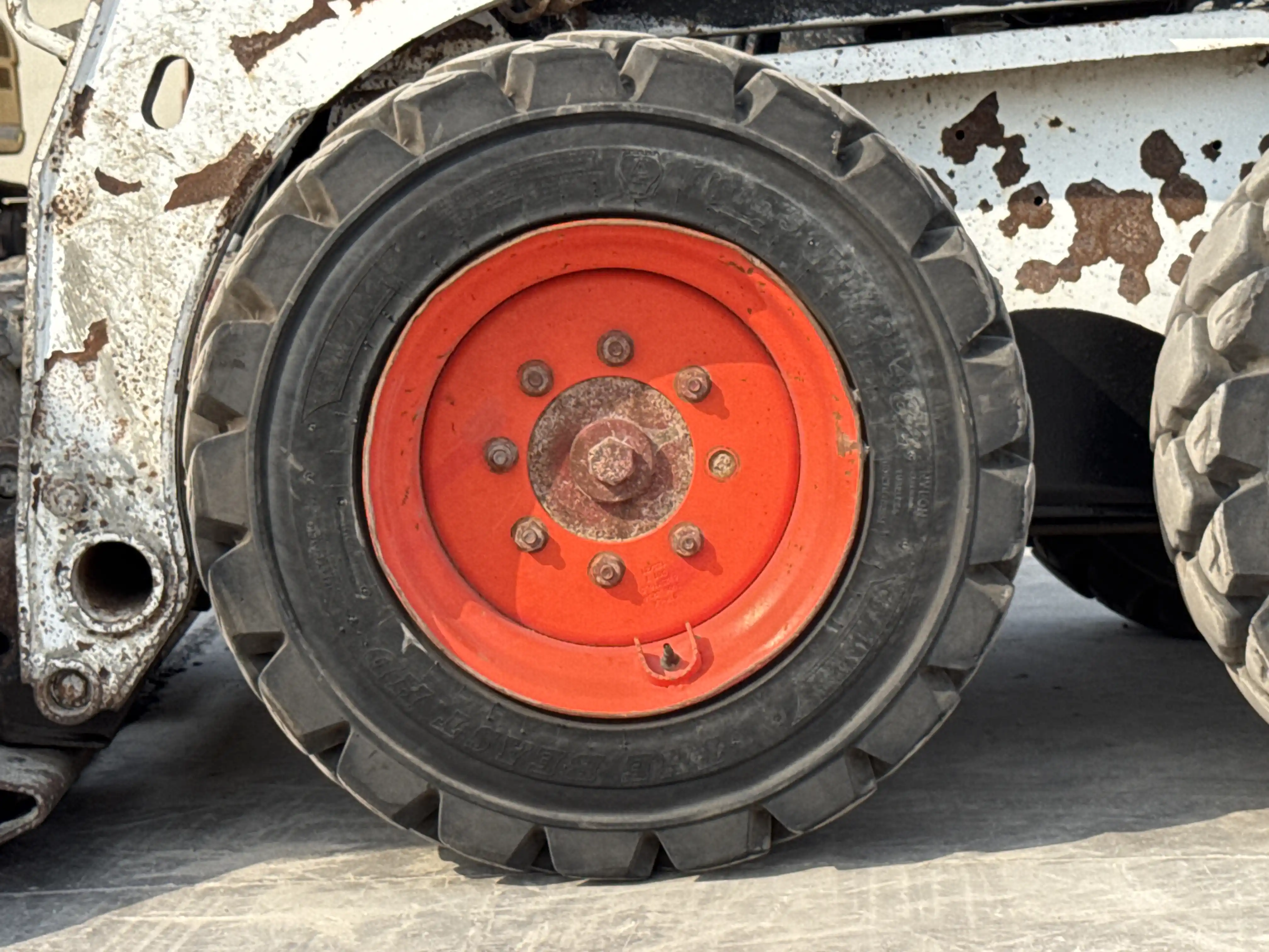 SSL-010-Bobcat-S450-skid-steer-loader-inspection-chassis-left-front-tire-wheel-hub-condition