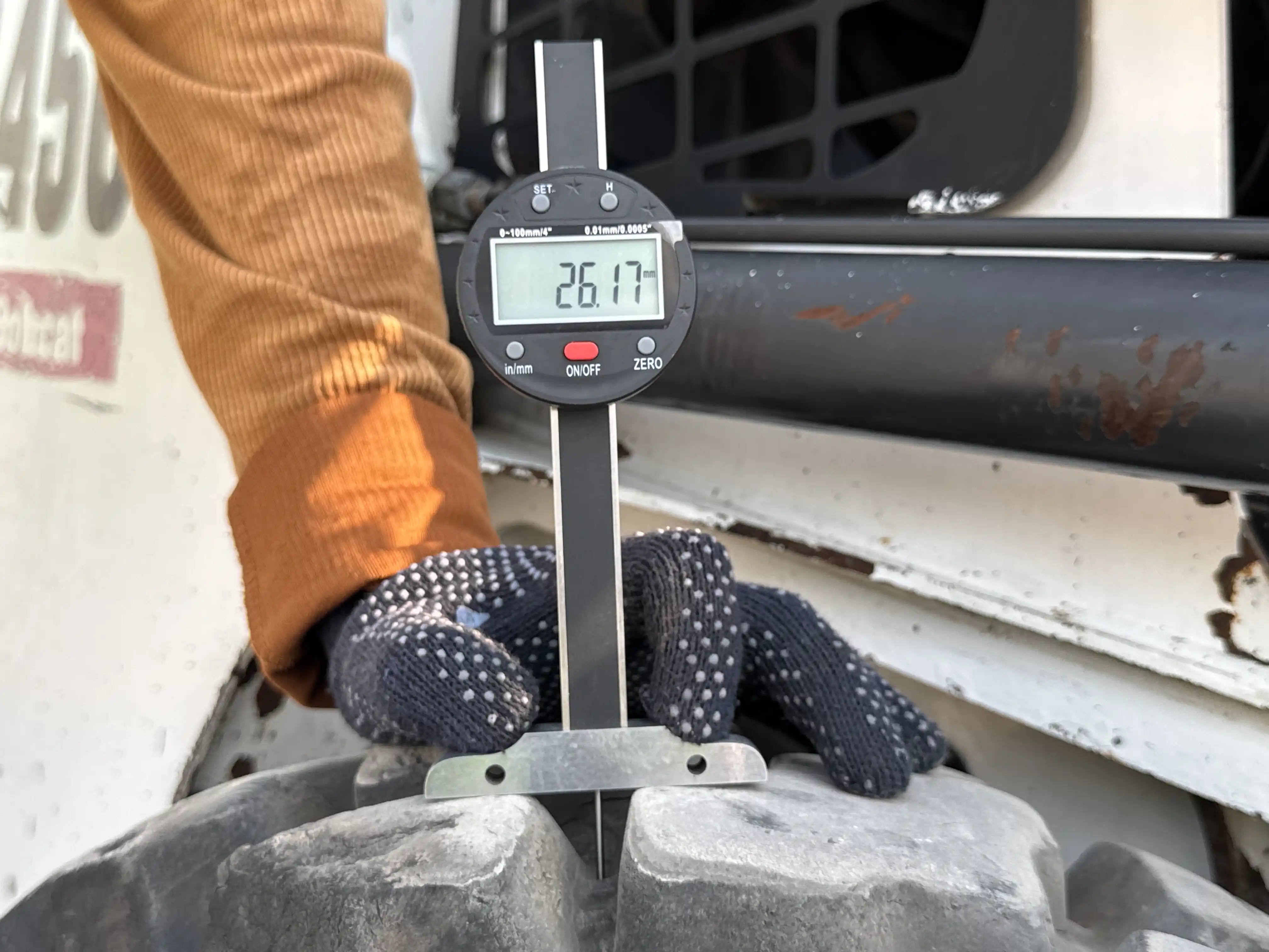 SSL-010-Bobcat-S450-skid-steer-loader-inspection-chassis-right-rear-tire-tread-depth