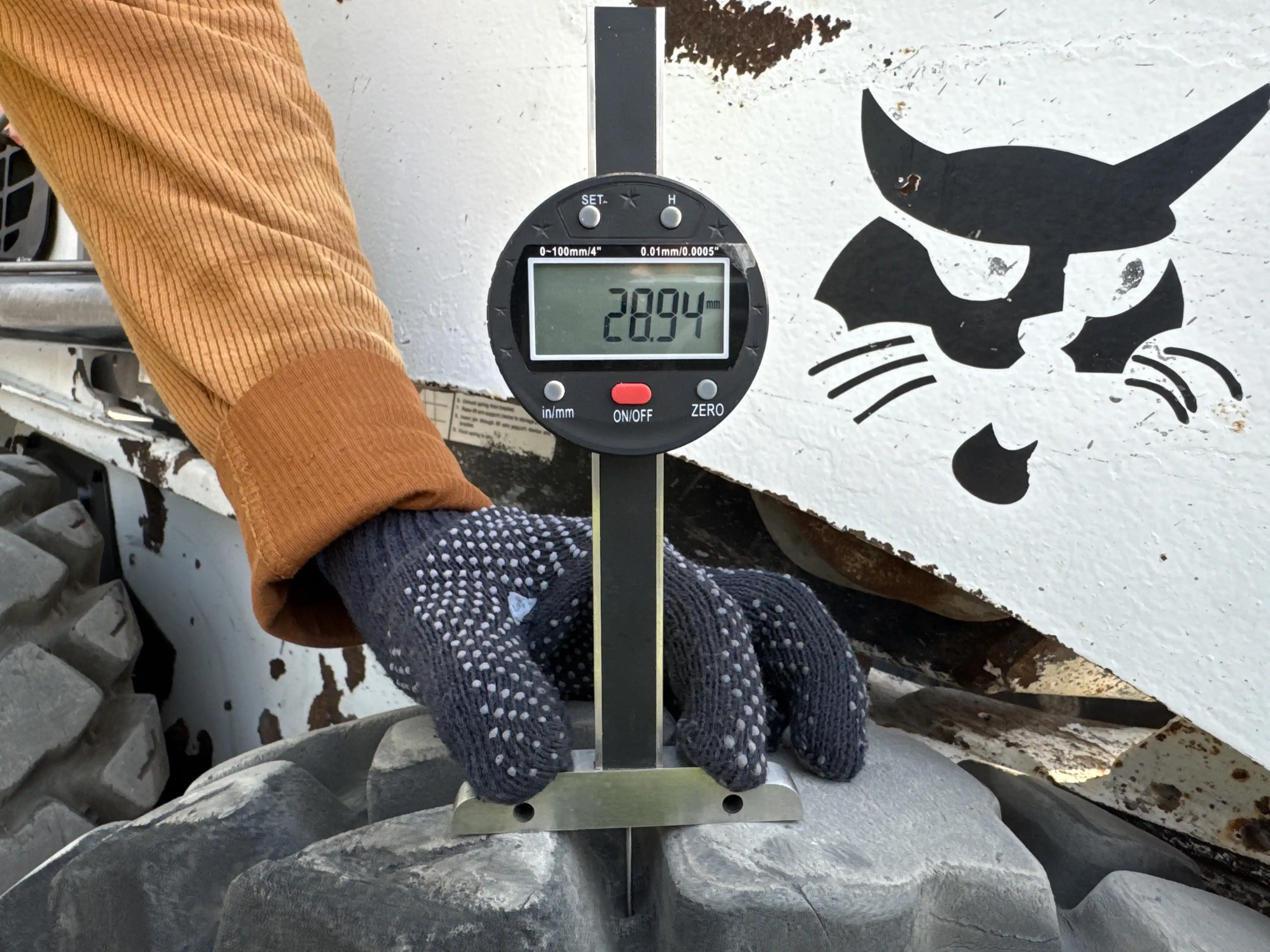 SSL-010-Bobcat-S450-skid-steer-loader-inspection-chassis-right-front-tire-tread-depth