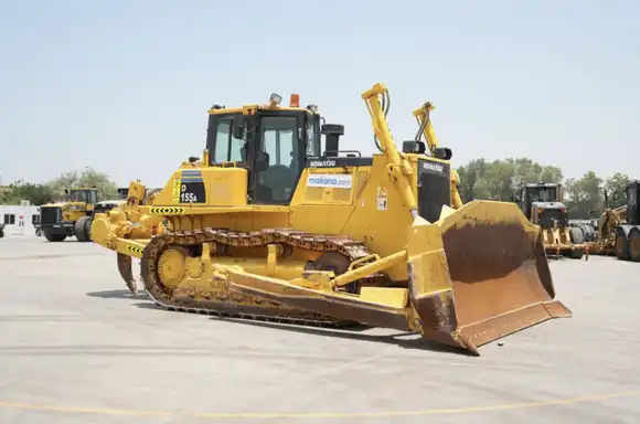 How much material can a Komatsu D155A move in an 8-hour shift?